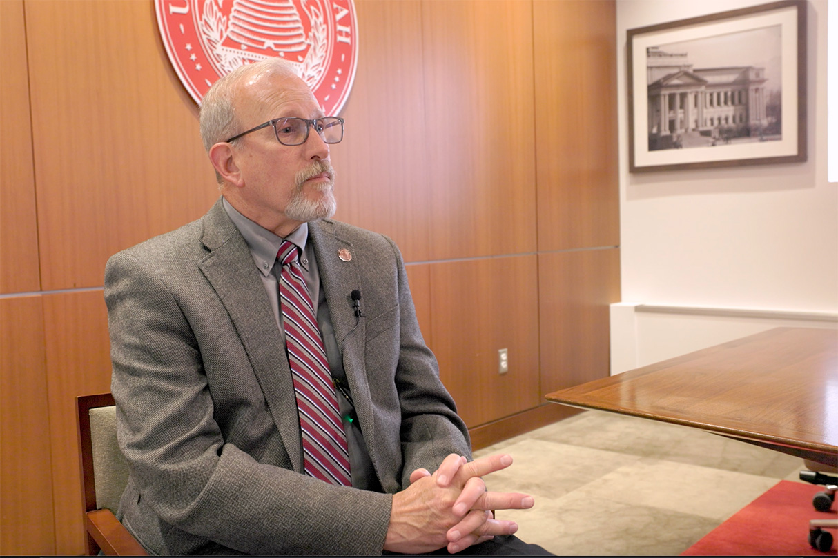 Image of man with a gray suit being interviewed